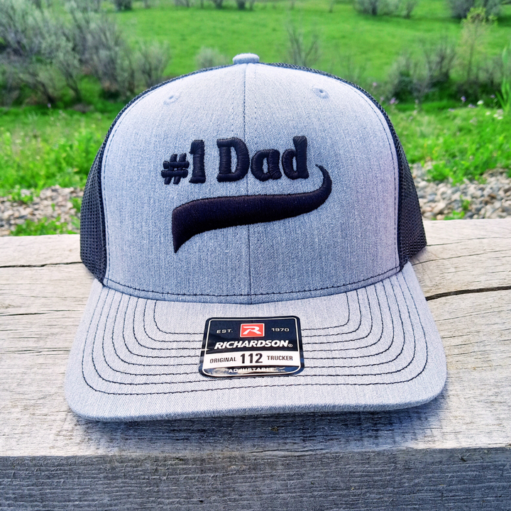 heather gray and black #1 dad 3d puff embroidered trucker cap hat with raised embossed look