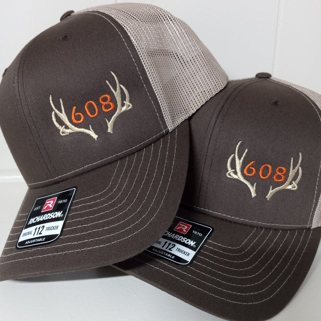 area code deer antler hat embroidered on a brown and khaki richardson 112 trucker cap hunter orange thread